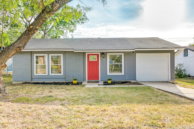 ranch-style house with a front yard and a garage