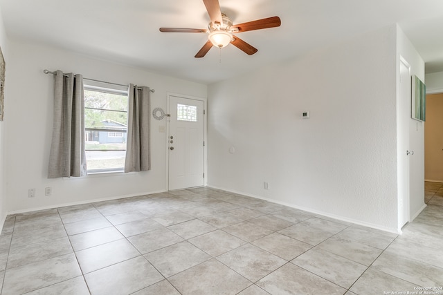 entryway with light tile patterned floors and ceiling fan