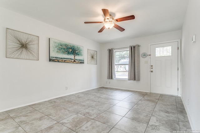 foyer featuring light tile patterned floors and ceiling fan