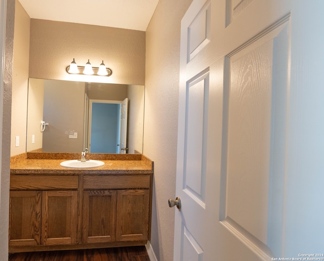 bathroom featuring hardwood / wood-style floors and vanity