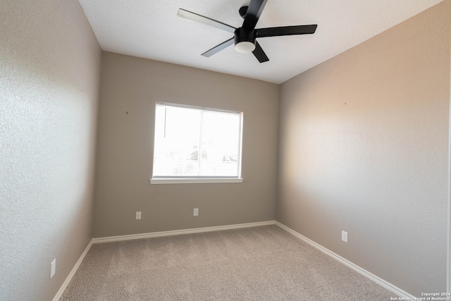 carpeted empty room featuring ceiling fan