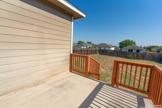 wooden deck featuring a lawn