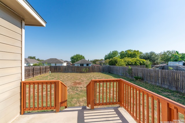 wooden deck featuring a yard