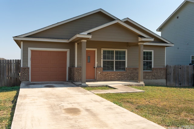 craftsman house with a porch, a garage, and a front lawn