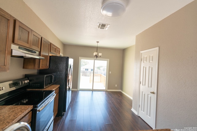 kitchen with dark hardwood / wood-style flooring, a textured ceiling, stainless steel appliances, an inviting chandelier, and hanging light fixtures