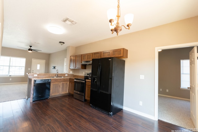 kitchen with black appliances, ceiling fan with notable chandelier, sink, decorative light fixtures, and dark hardwood / wood-style flooring