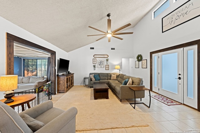 tiled living room with a textured ceiling, high vaulted ceiling, and ceiling fan