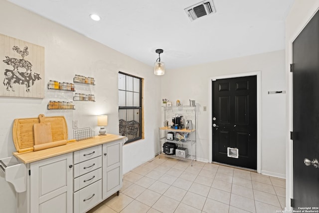 entryway with light tile patterned floors