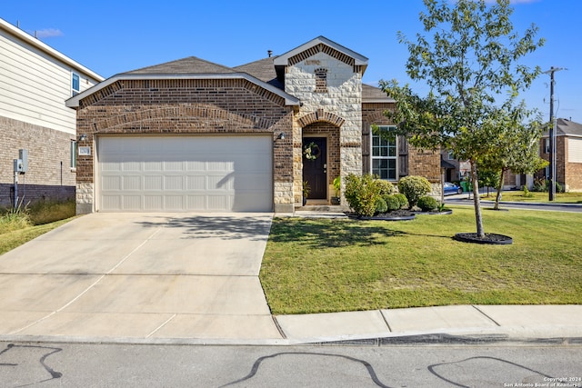 view of front facade with a front yard and a garage