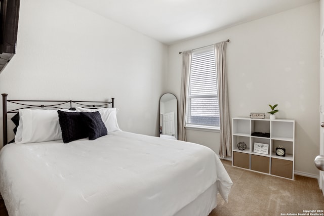 bedroom with light colored carpet