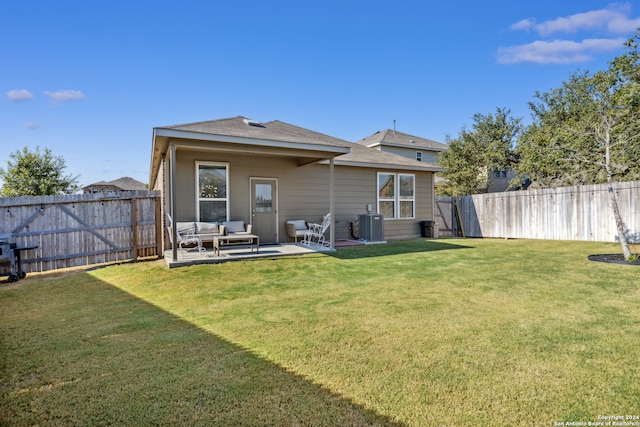 back of property with a patio, outdoor lounge area, and a lawn