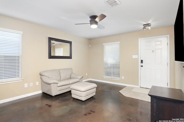 sitting room featuring ceiling fan and a wealth of natural light