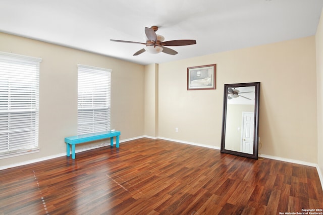 empty room with dark wood-type flooring and ceiling fan