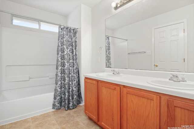 bathroom with vanity, shower / bathtub combination with curtain, and tile patterned flooring