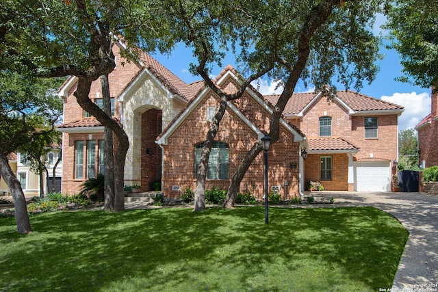 view of front of home featuring a garage and a front lawn