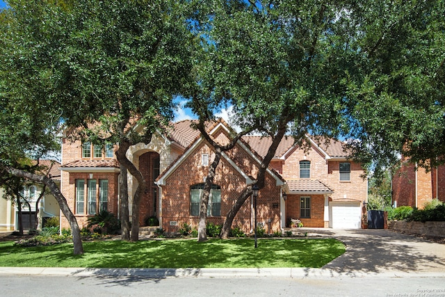 view of front of property with a front yard and a garage