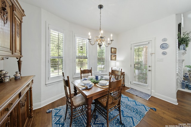 dining space with a wealth of natural light, dark hardwood / wood-style floors, and an inviting chandelier