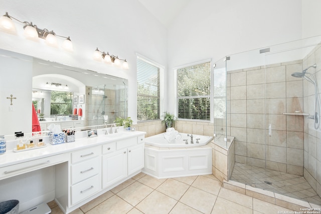 bathroom featuring vanity, tile patterned floors, separate shower and tub, and vaulted ceiling