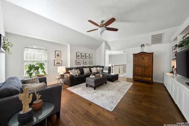 living room featuring dark hardwood / wood-style flooring, a textured ceiling, ceiling fan, and vaulted ceiling