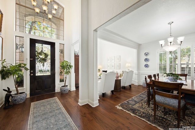 entryway featuring dark hardwood / wood-style flooring, an inviting chandelier, and a wealth of natural light