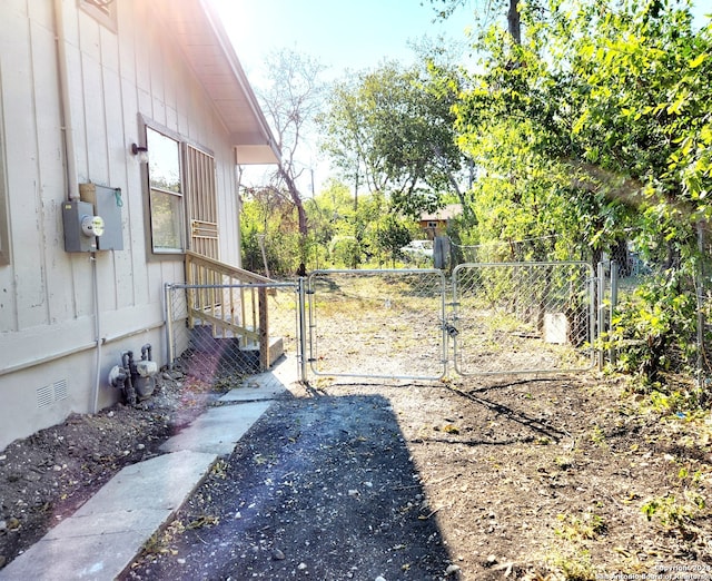 view of yard featuring fence and a gate