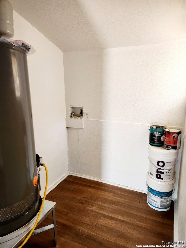 interior space featuring baseboards, wood finished floors, and gas water heater