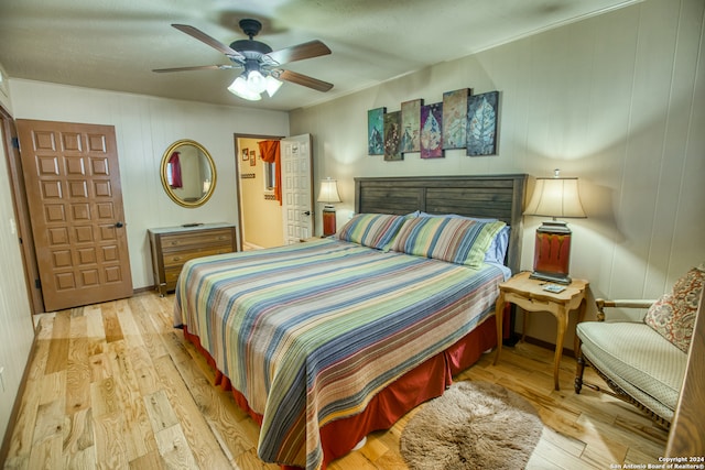 bedroom with light hardwood / wood-style floors and ceiling fan