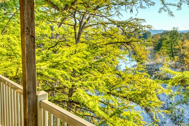 balcony featuring a water and mountain view