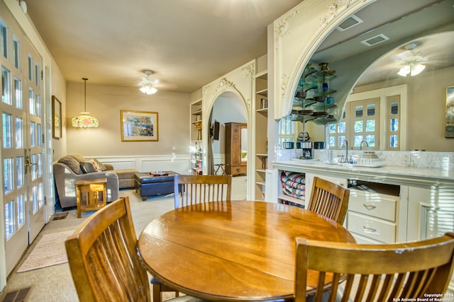 dining space featuring french doors, ceiling fan, and plenty of natural light