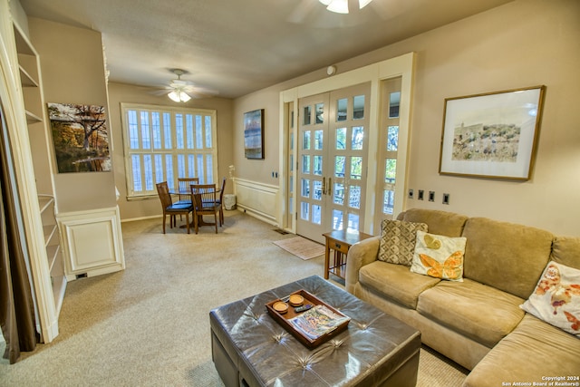 carpeted living room with ceiling fan