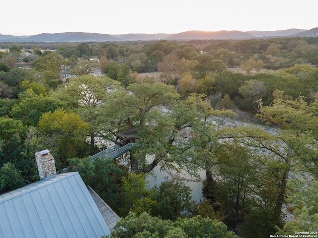 aerial view at dusk featuring a mountain view