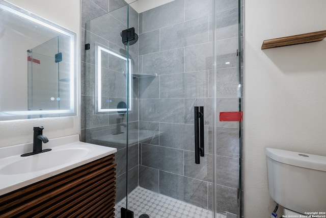 bathroom with vanity, an enclosed shower, and toilet