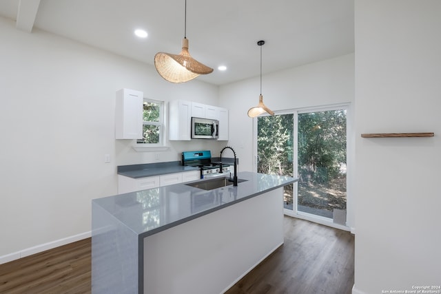 kitchen featuring white cabinetry, black gas range oven, pendant lighting, and dark hardwood / wood-style floors