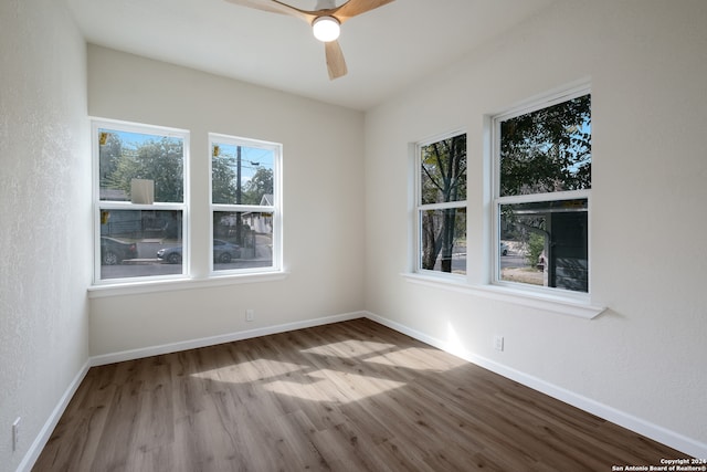 spare room with light wood-type flooring and ceiling fan