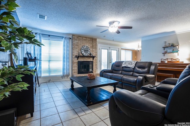 living room featuring a brick fireplace, ornamental molding, light tile patterned floors, and a wealth of natural light