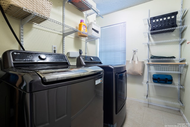 washroom with washing machine and dryer