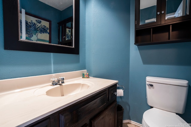 bathroom with toilet and vanity