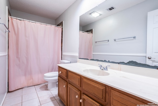 bathroom with a textured ceiling, a shower with shower curtain, toilet, tile patterned floors, and vanity