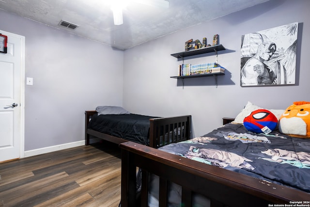 bedroom with dark wood-type flooring and ceiling fan