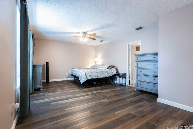 bedroom with dark hardwood / wood-style floors, a textured ceiling, and ceiling fan