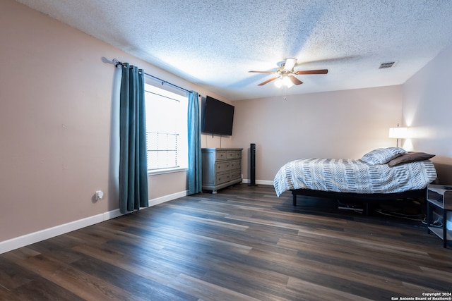 bedroom featuring ceiling fan, a textured ceiling, and dark hardwood / wood-style flooring