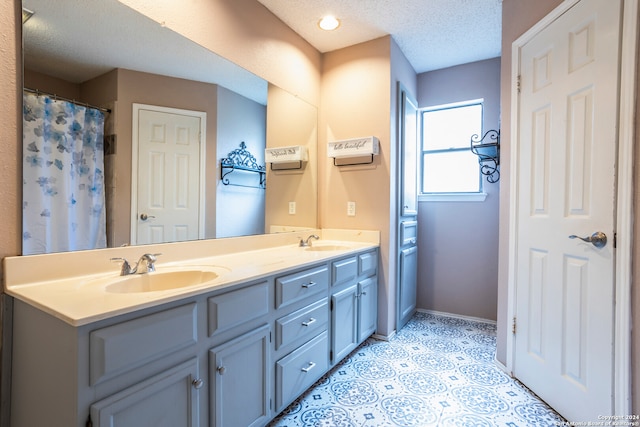 bathroom with vanity and a textured ceiling