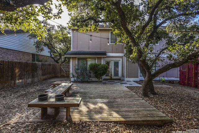 rear view of property featuring a wooden deck