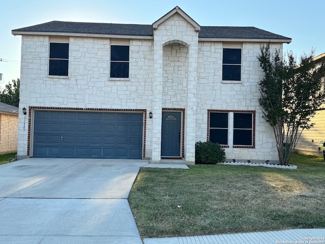 view of front facade featuring a front lawn and a garage