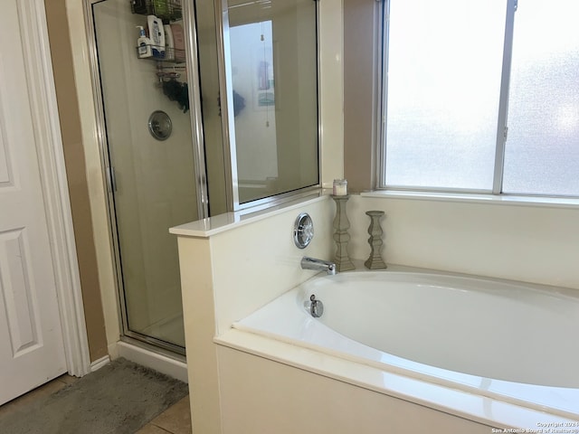 bathroom with tile patterned floors and plus walk in shower