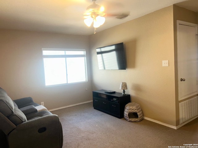 living area featuring ceiling fan and carpet flooring