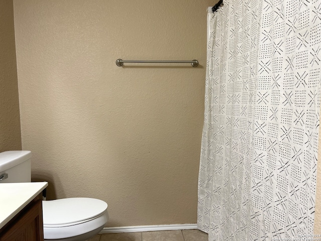 bathroom featuring vanity, toilet, and tile patterned flooring