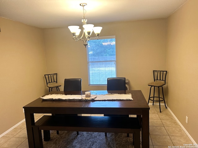 tiled dining space with an inviting chandelier