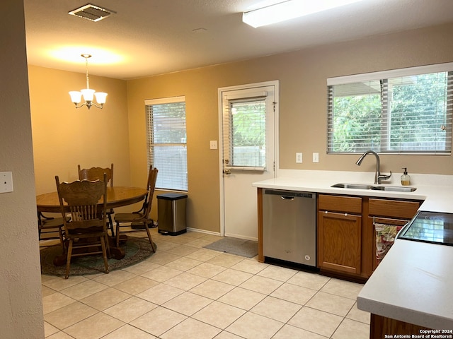 kitchen featuring sink, dishwasher, hanging light fixtures, and light tile patterned floors