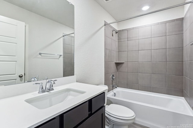 full bathroom featuring vanity, toilet, and tiled shower / bath combo